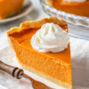 Pumpkin pie slice on a plate.