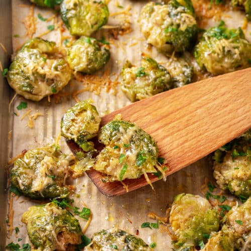 Close up of baked brussels sprouts on a baking dish.