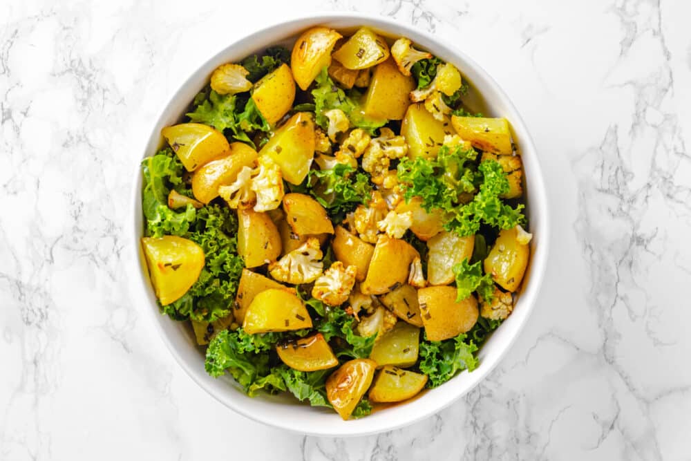 roasted potato salad with fresh kale and dressing.