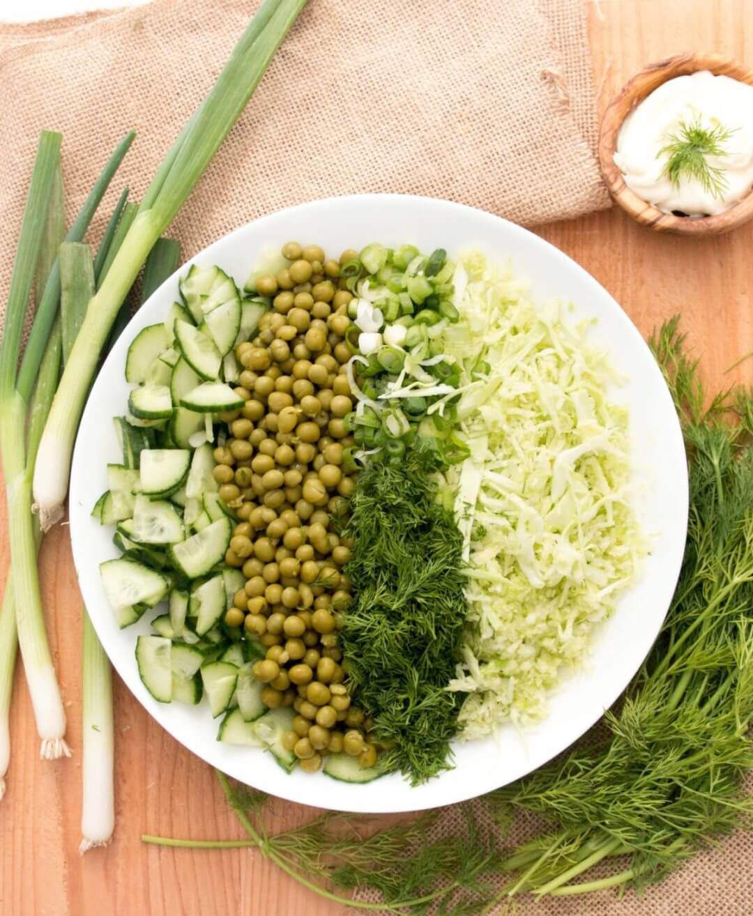 cabbage-salad-on-a-white-plate-with-greens-around