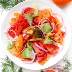 tomato-salad-on-a-white-plate-with-dill-on-the-side