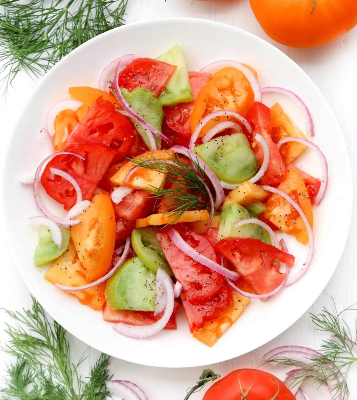 tomato-salad-on-a-white-plate-with-dill-on-the-side