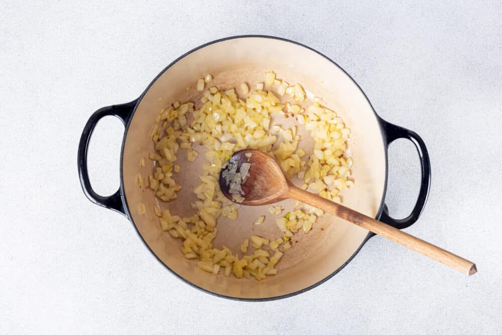 Sautéed onion in a cast iron pot.