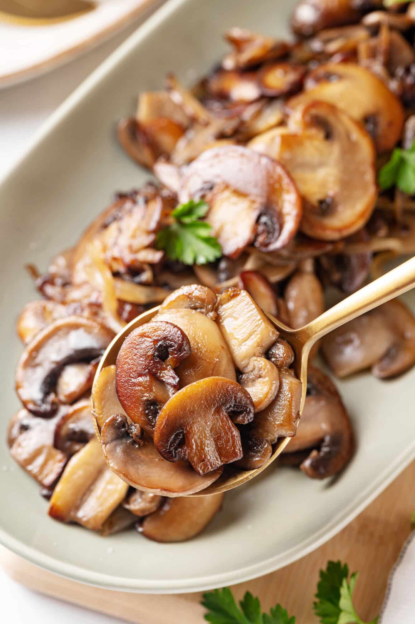 Sautéed mushrooms with onion on a spoon ready to serve.