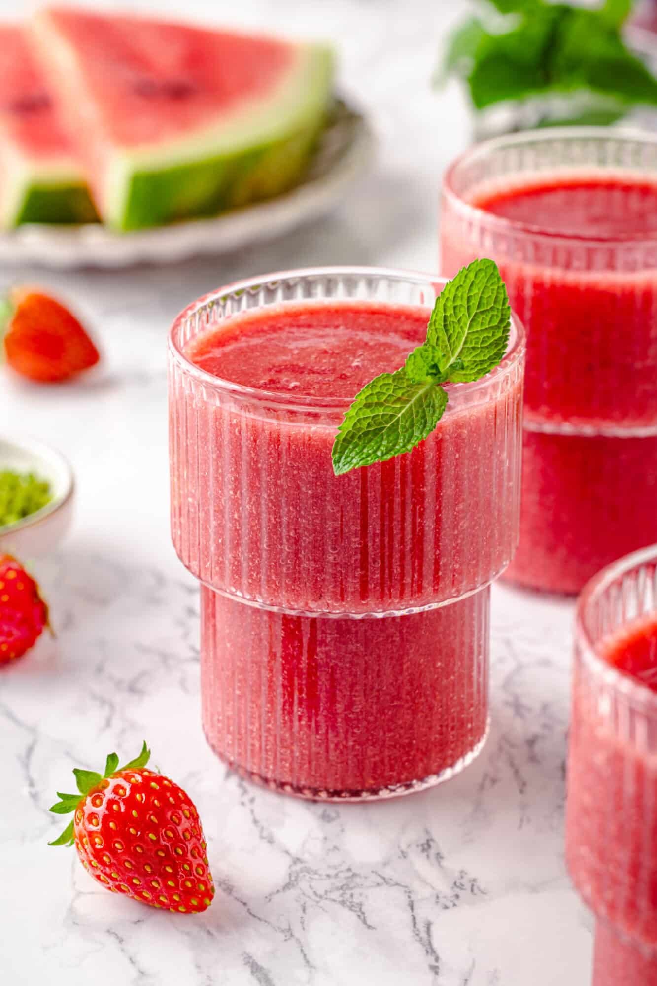 Serving strawberry smoothie with mint.