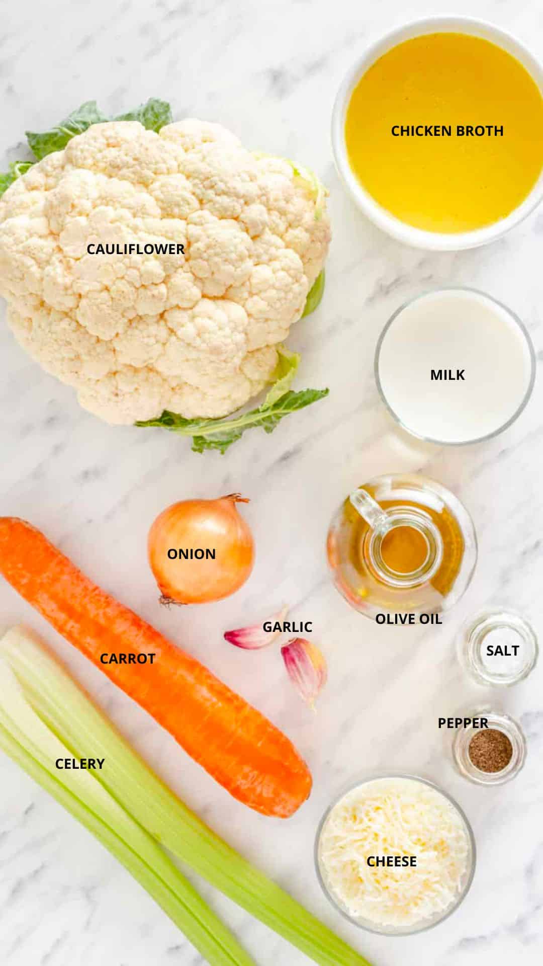 cauliflower soup with cheese ingredients spread- chicken broth, cauliflower, milk, olive oil, onion, garlic, salt, pepper, cheese, carrot, and celery.