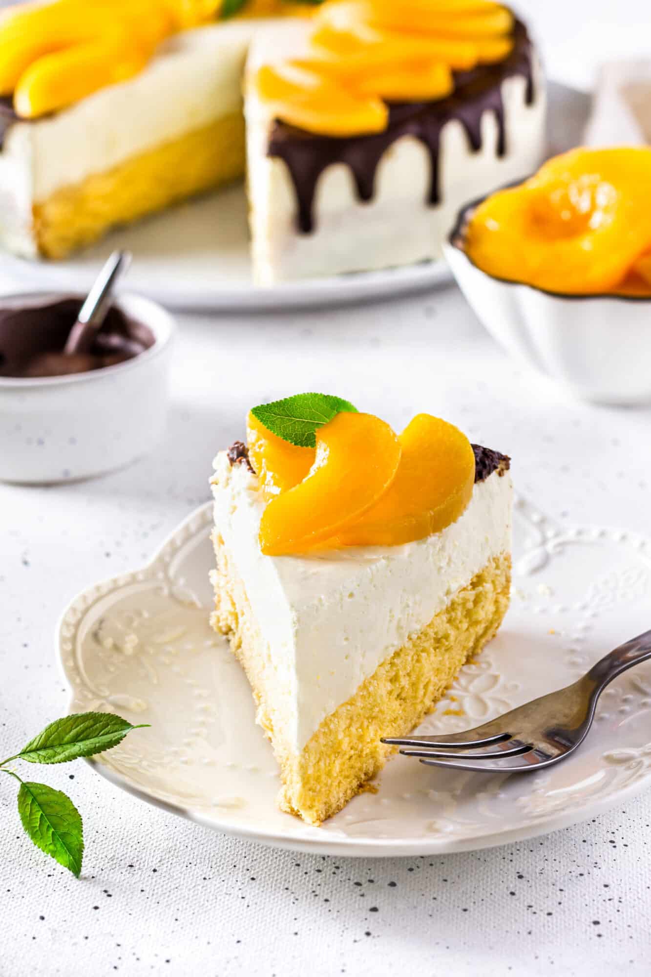 Slice of peach mousse cake on a white plate.