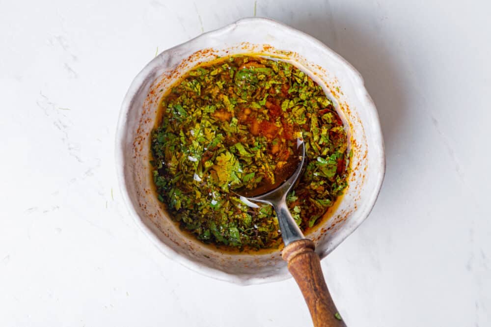 Dressing in a bowl with a spoon.