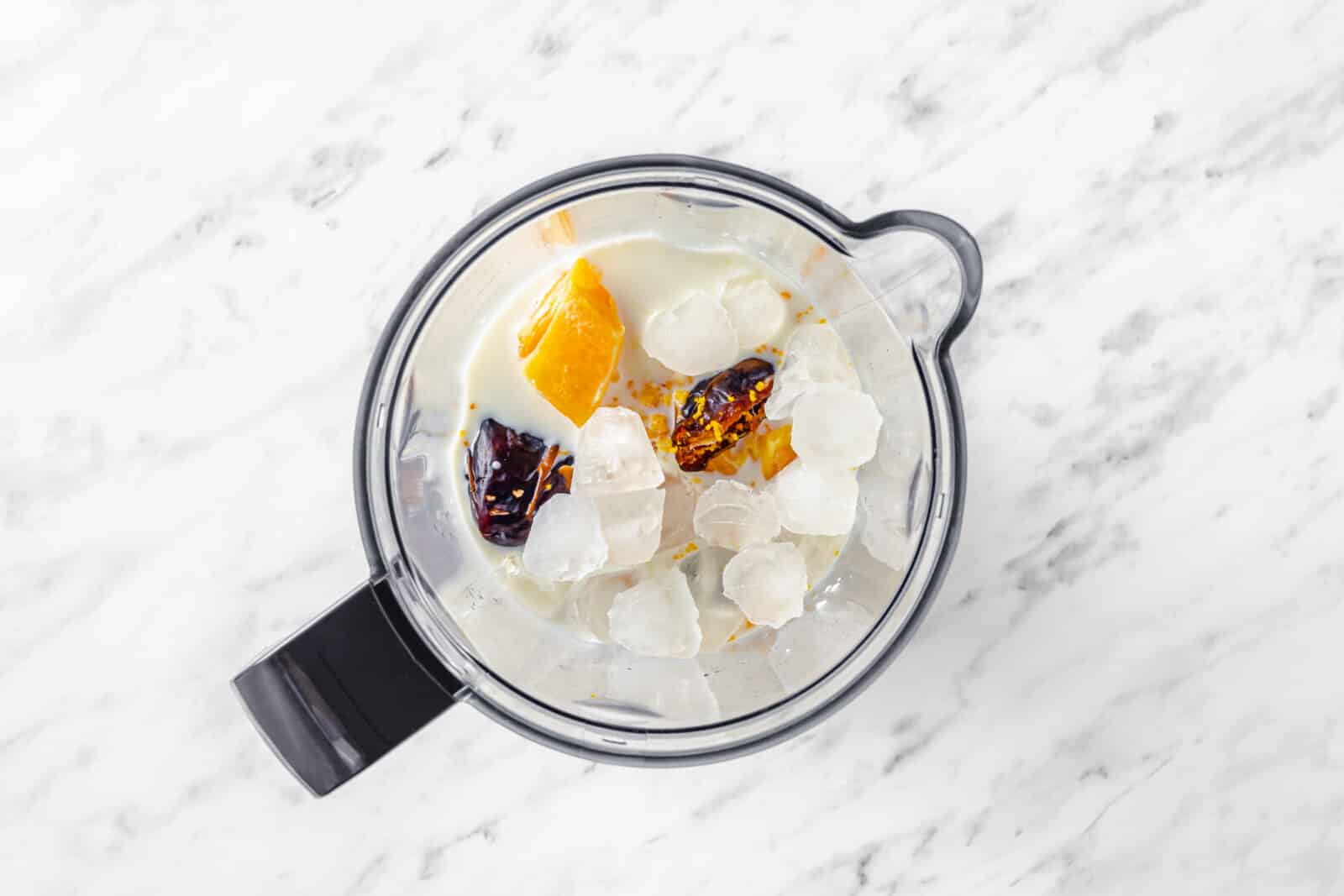 Smoothie ingredients in a blender bowl.