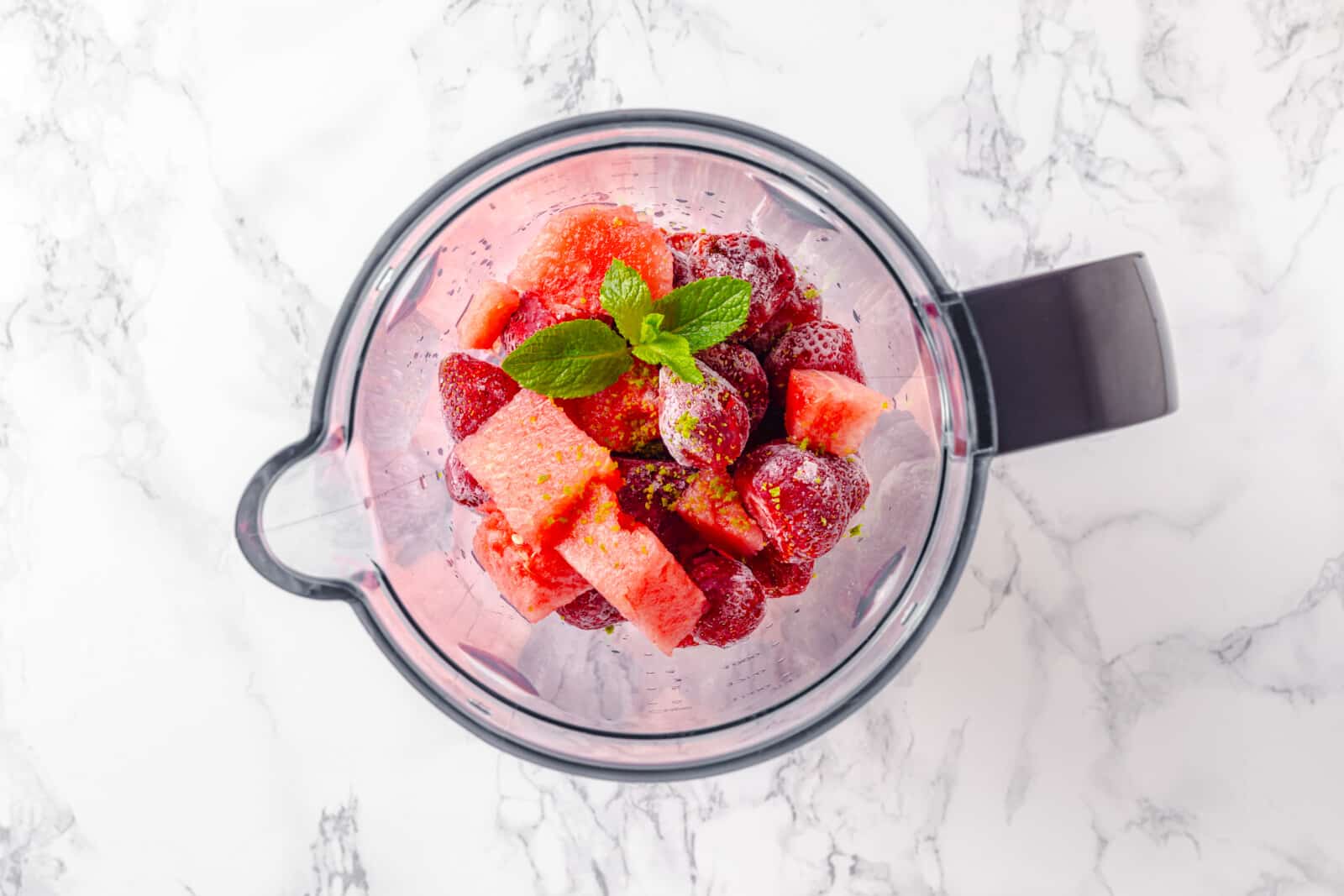 Smoothie ingredients in a blender, ready to blend.