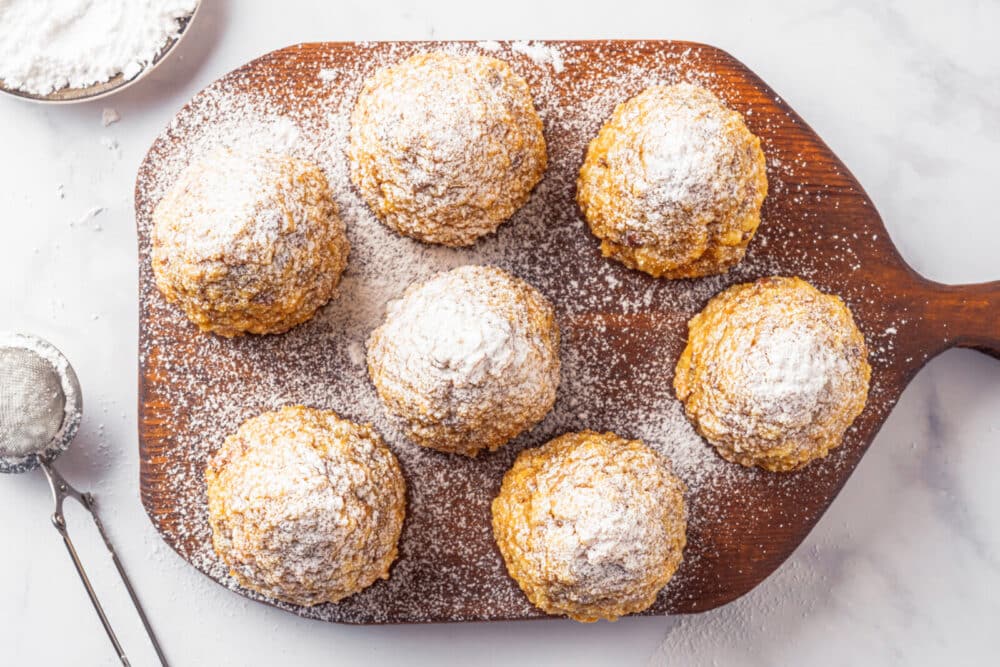 Sweet winter trees on a wooden board covered in powdered sugar.