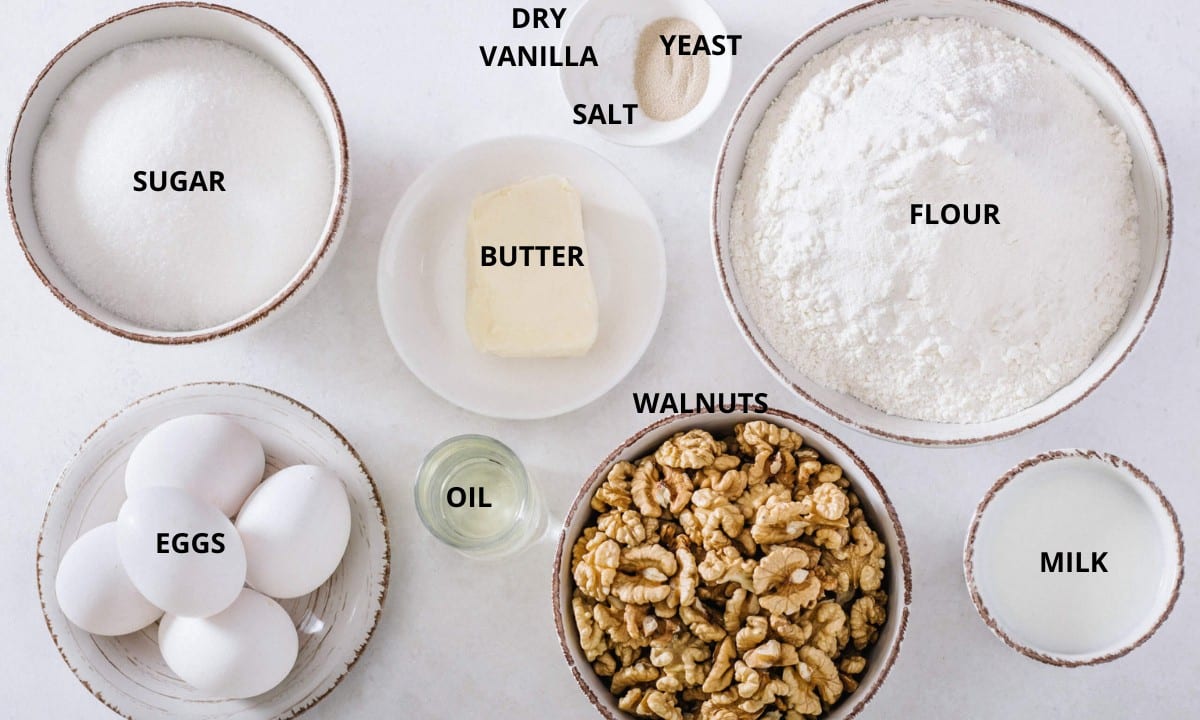 ingredients for walnut roll , flour, sugar, walnuts, yeast, eggs, oil, salt, vanilla, butter.