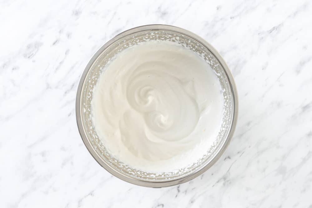 Whipped cream in a silver bowl.