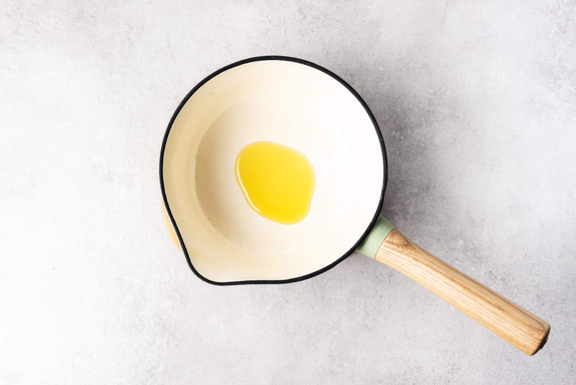 a saucepan with olive oil in it.