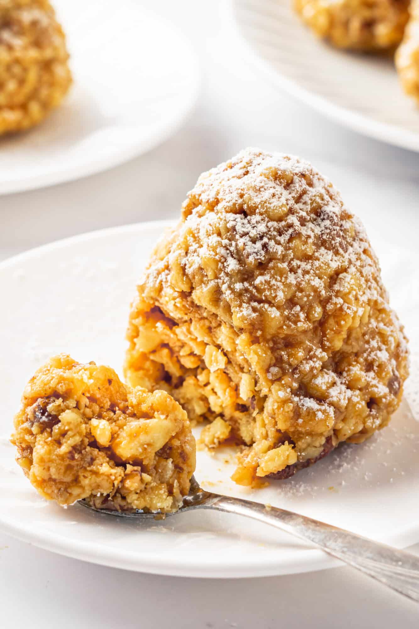 Winter tree on a white plate covered in powdered sugar, eating with a spoon.